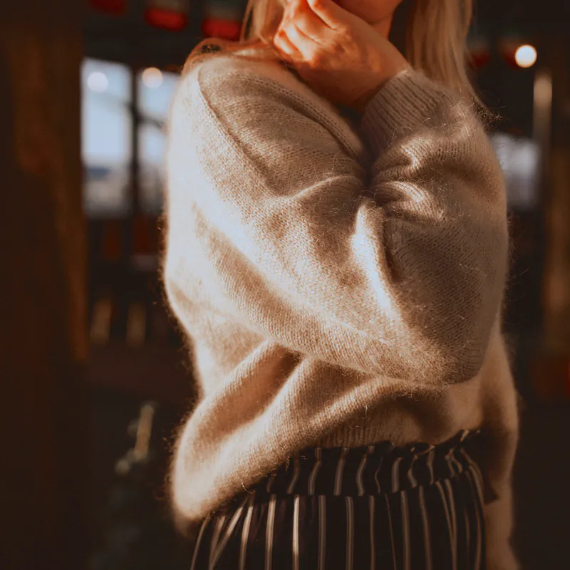 A close up of the seamless sleeve detail on the handknit Ridgeline Sweater. It's beige and slightly fuzzy because of the mohair content.