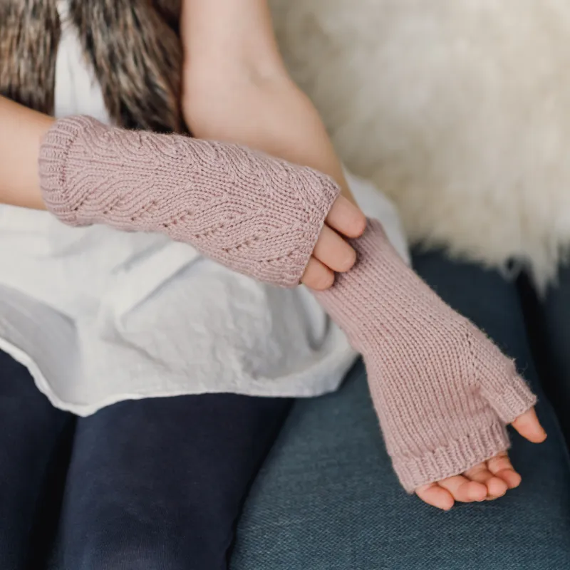 Pink fingerless gloves with a view of the lace detail on one side and the palm of the other hand