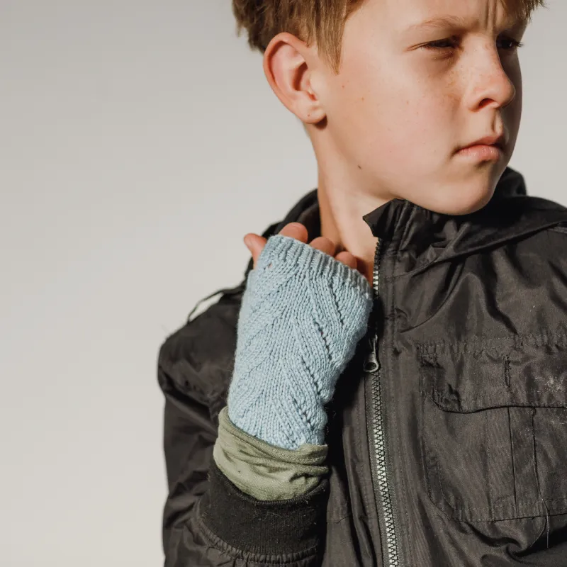 Boy wearing hand knitted fingerless gloves