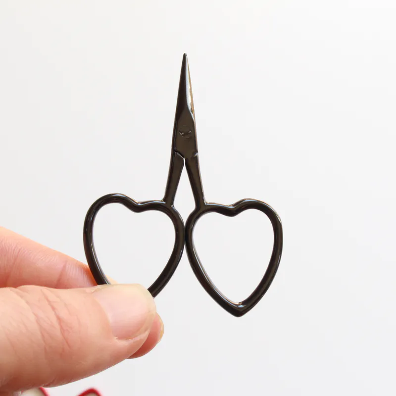 Black scissors with heart shaped handles
