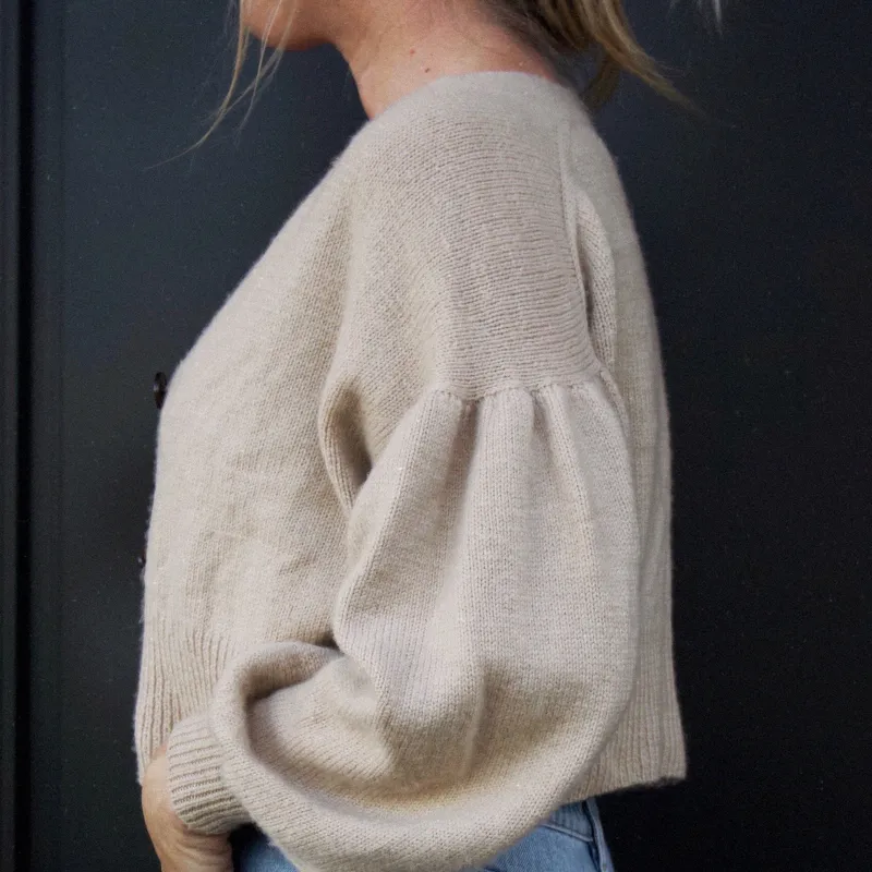 Side view of the Gather Sleeve Cardi knitting pattern in a tan colour. The yarn is NZ merino from Wild Earth Yarns in NZ.