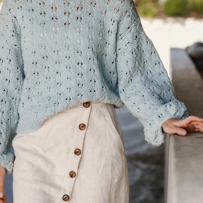 Lace details on a pale blue hand knit sweater