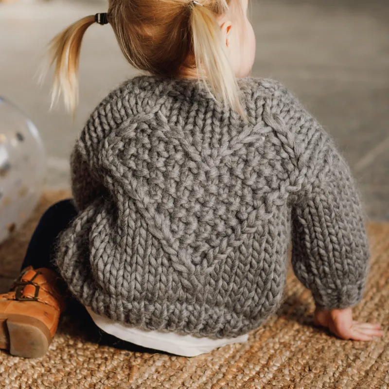 Hand knit cardigan for child using chunky grey yarn