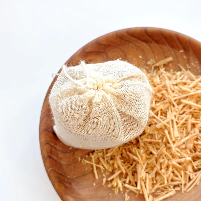 A bag of Himalayan Cedar chips. Sitting in a bowl of cedar chips on the right top corner.