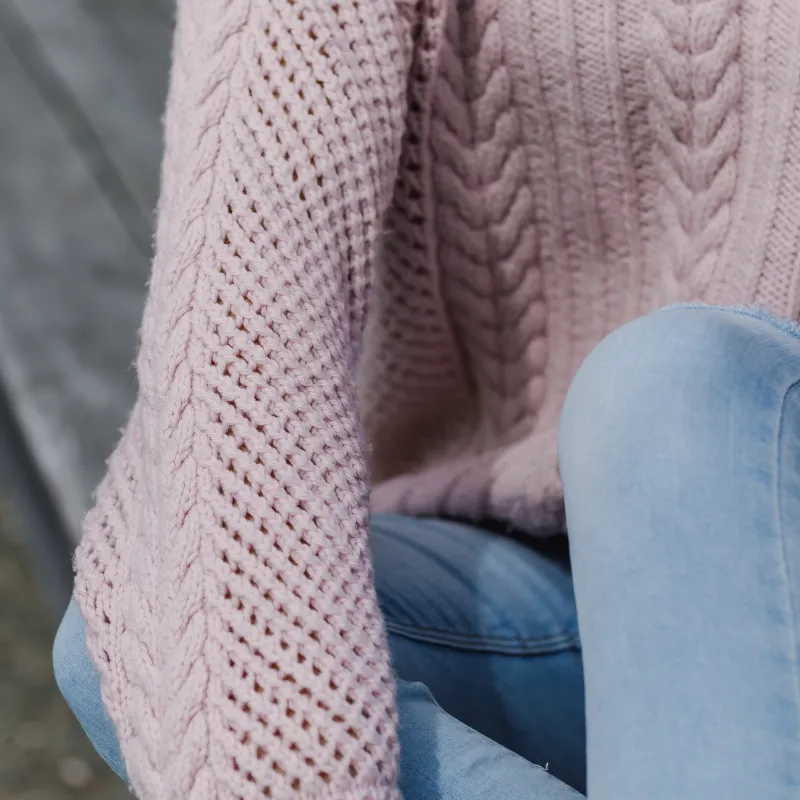 A hand knit sweater with mesh and cable sleeves