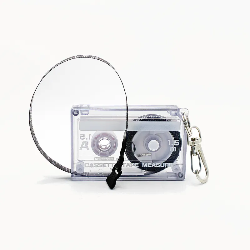 A tape measure in the shape of an 80s cassette tape. It looks clear but it's actually a grey colour.