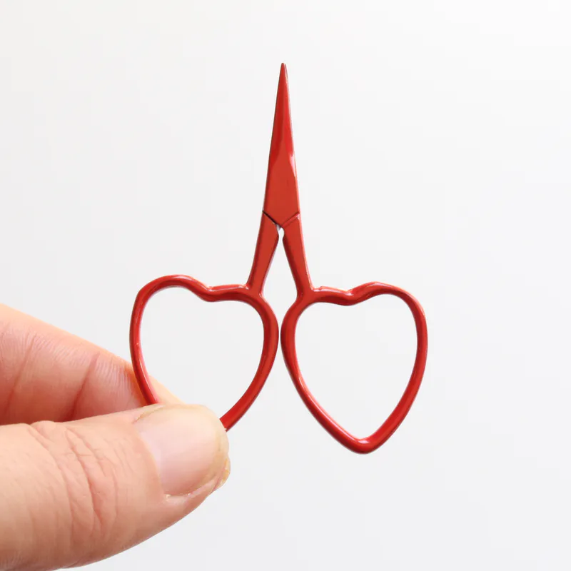Red scissors with heart shaped handles