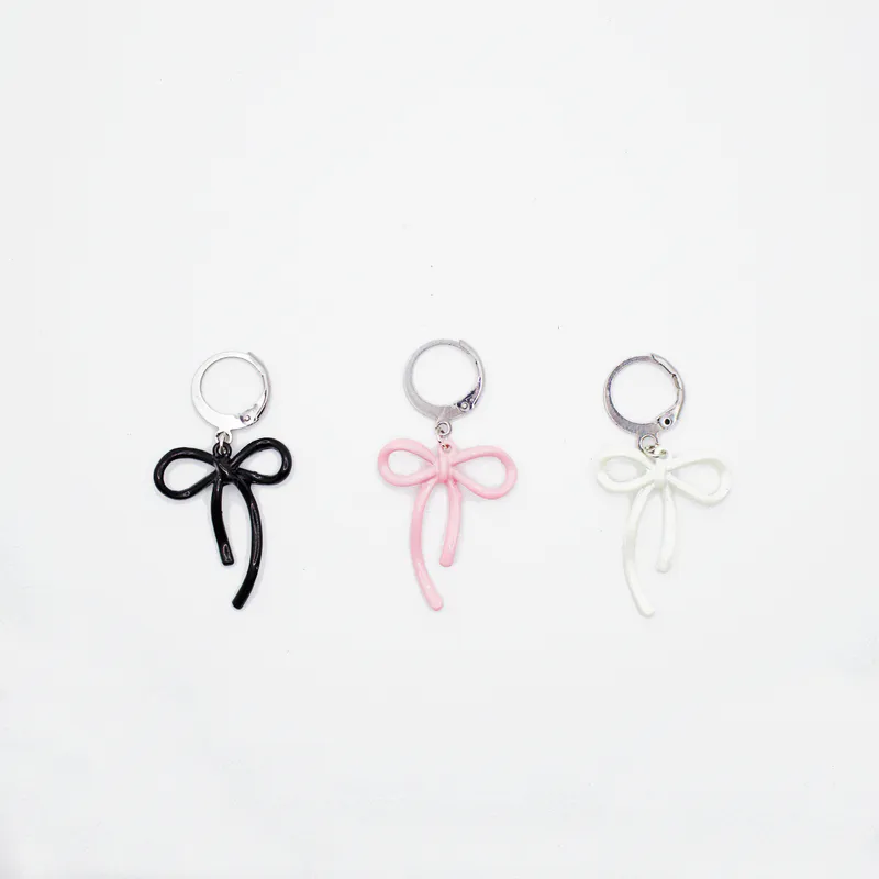 Set of three bow shaped knitting markers in black, pink and white colours