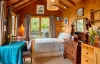Chalet interior with double bed and dining table