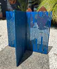 Anodised bright blue aluminium sculpture that interlocks by Peter Muller, available at The Little Gallery in Tairua