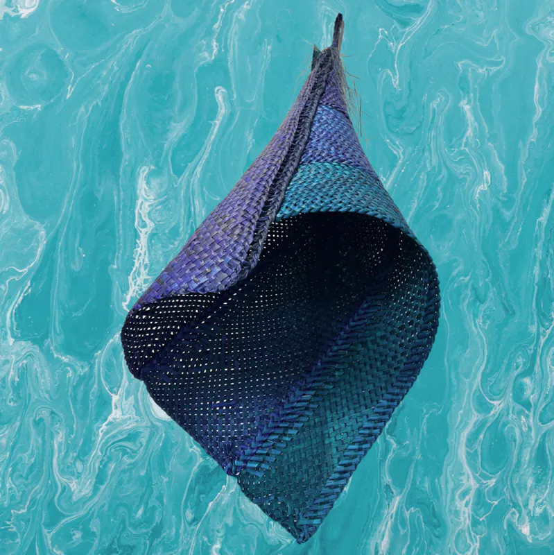 Hanging handwoven dyed Harakeke traditional Maori Hinaki by New Zealand artist Bernie Ross, available at The Little Gallery Whangamata