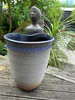 A handmade coiled clay pot with figure by New Zealand artist Ian Webster, available at The Little Gallery Tairua