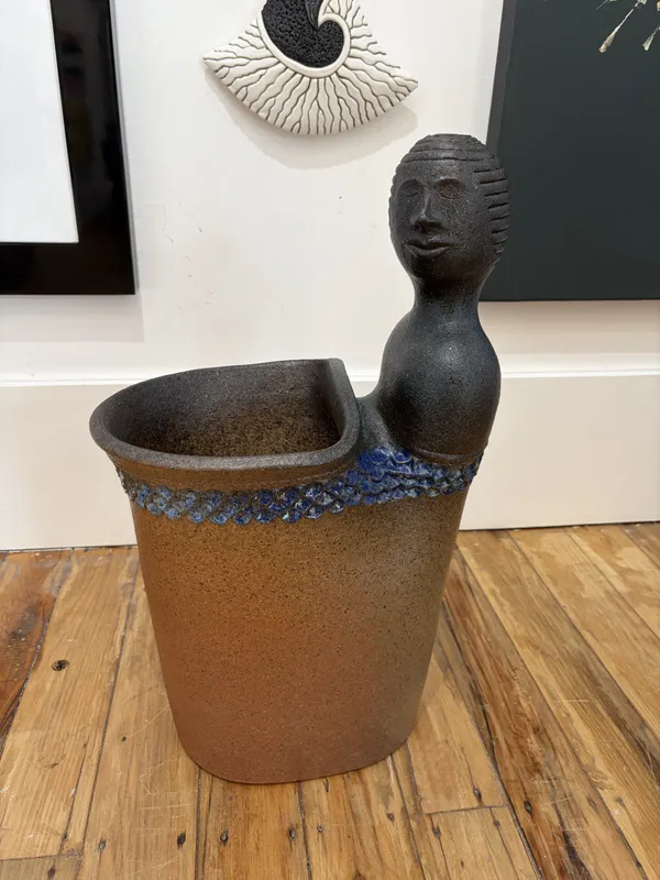 A handmade clay planter with head and blue details by Ian Webster, available at The Little Gallery Tairua