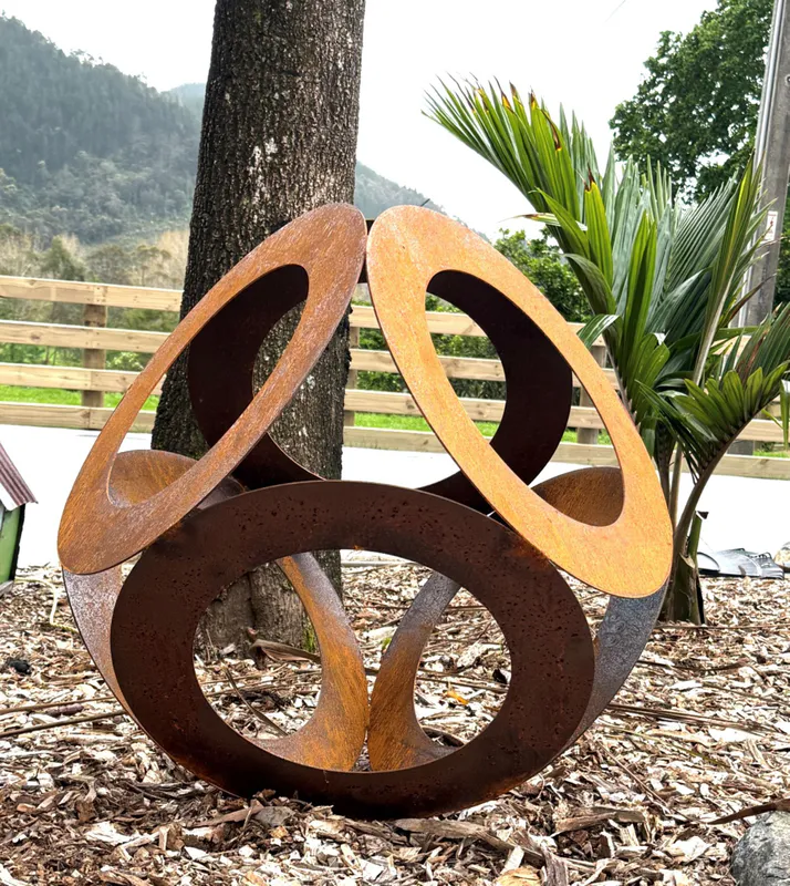 Large rusty Corten Steel garden art sphere by New Zealand artist Rustic Soul Sculptures, available at The Little Gallery Whangamata