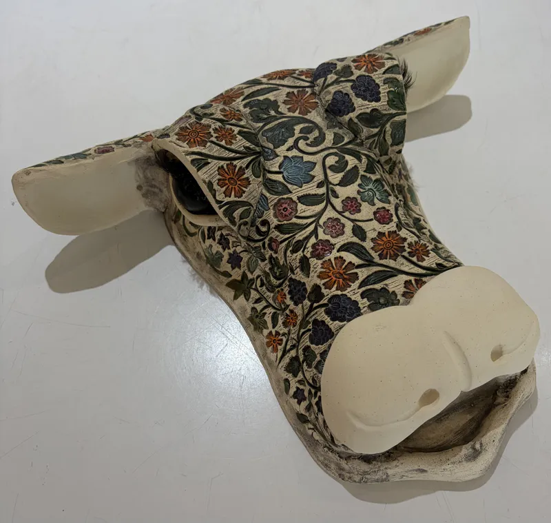 A Ceramic Cow's Head with a colourful tattooed design by Studio 12 Art, available at The Little Gallery Tairua