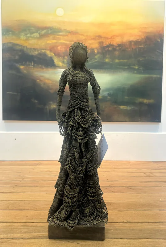 An elegant fabric and Paverpol sculpture of a lady in a dress by Shona MacDoland, available at The Little Gallery Tairua