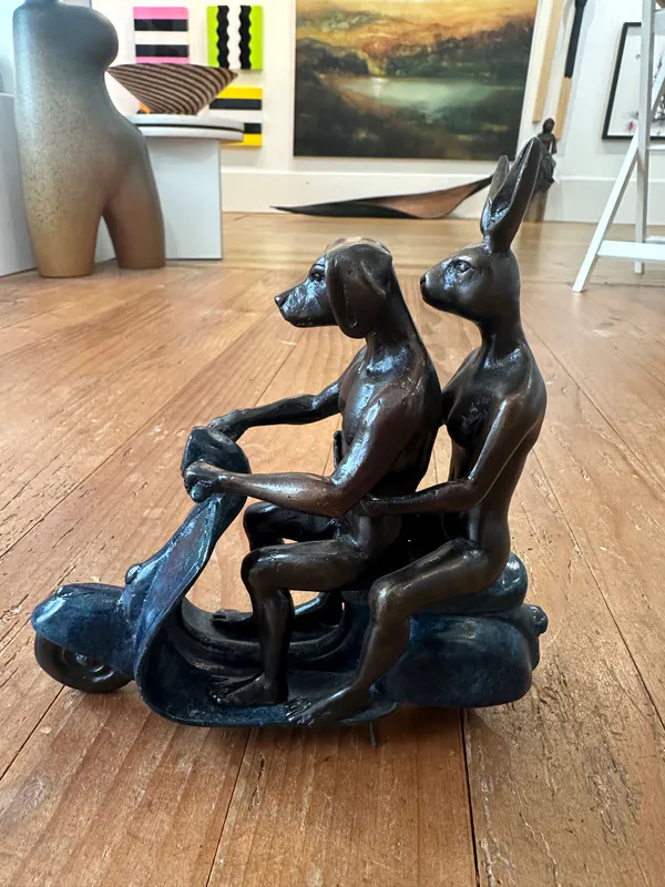 Dogman and Rabbitwoman bronze sculpture on a blue patina vespa by Gillie and Marc available at The Little Gallery in Tairua