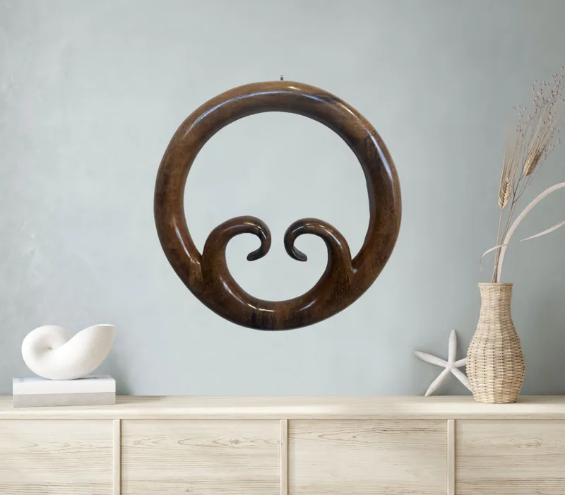 A beautifully hand-carved Pacific Puriri Wood Heart by Ron Stark, available at The Little Gallery Whangamatā