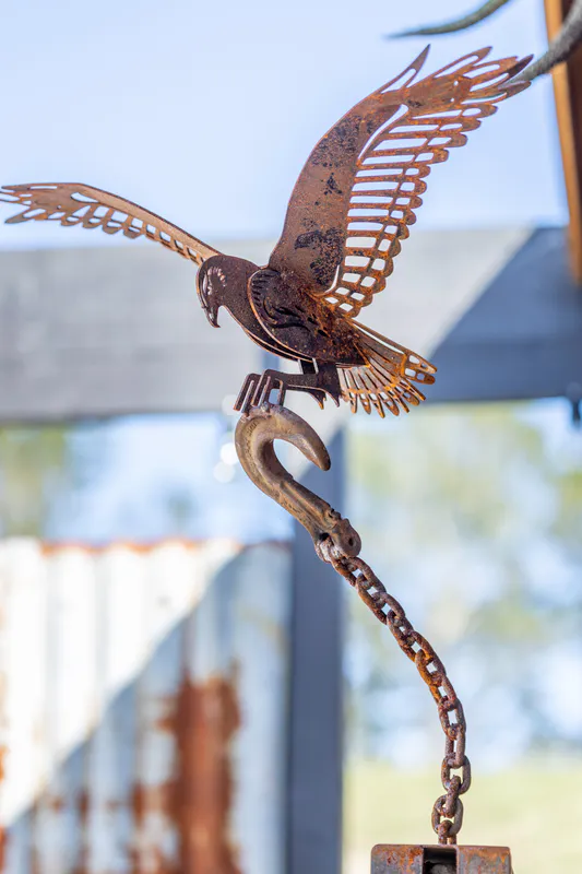 Up close detail of Corten Steel Kahu on rusty chain by Rustic Soul Sculptures, available at The Little Gallery Whangamata