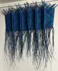 A blue-dyed Harakeke woven into a wall hanging by Bernie Ross, available at The Little Gallery Tairua