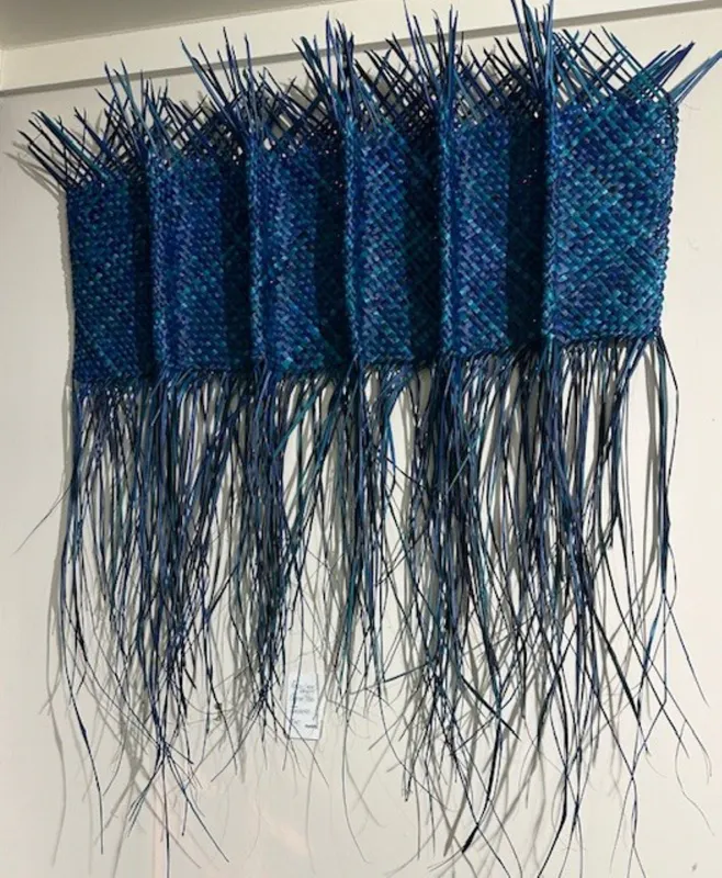 A blue-dyed Harakeke woven into a wall hanging by Bernie Ross, available at The Little Gallery Tairua