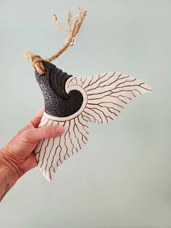 A beautifully crafted ceramic Whale Tail wall hanging by Jo Richards Hooker, available at The Little Gallery Tairua