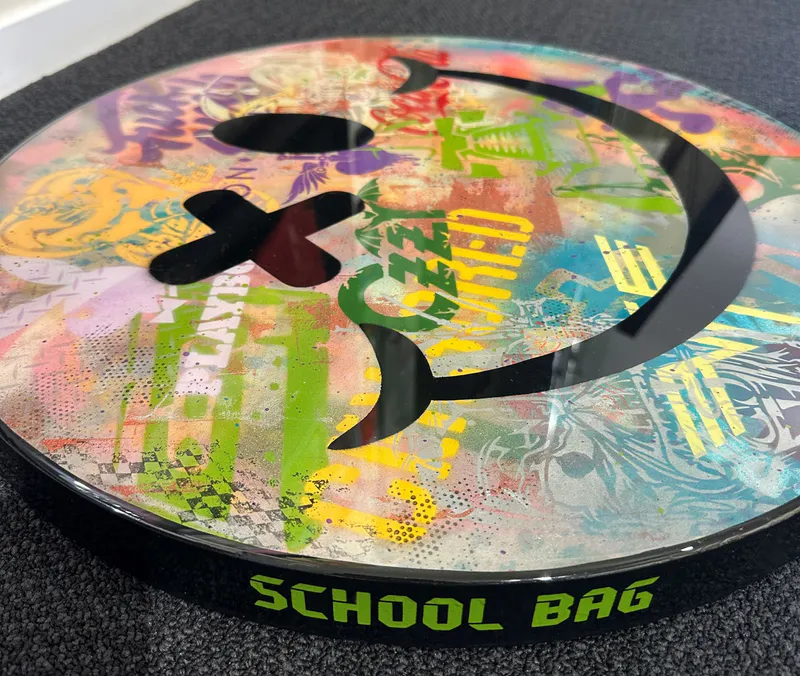 A side view of a Pop Art piece with logos by Random Guy, available at The Little Gallery Whangamata
