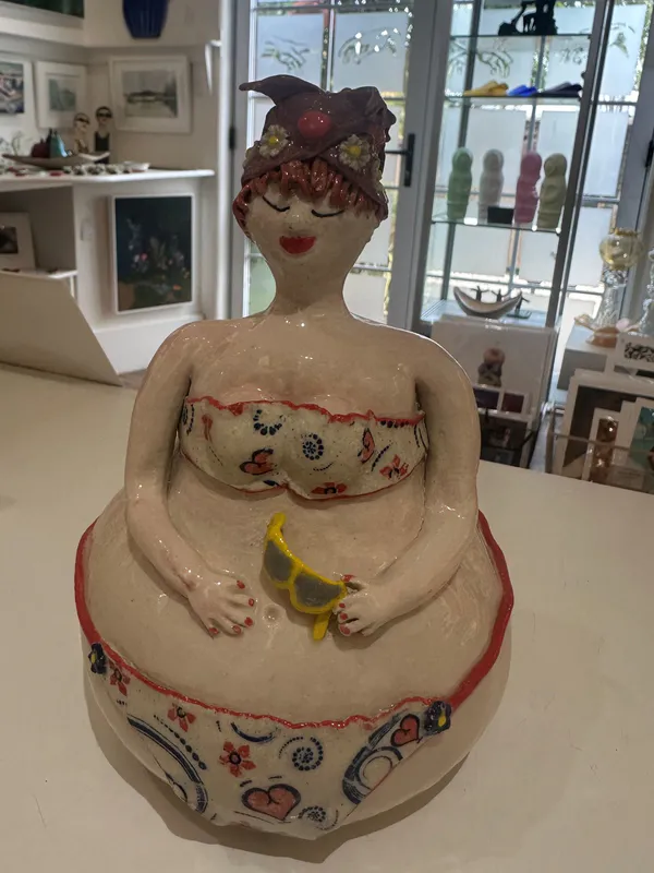 An original quirky ceramic figure of a lady in a heart-patterned bikini by LeeBee, available at The Little Gallery Whangamatā