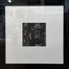 An original monochromatic Monoprint with large white mat and slick black frame by Peter Augustin, available at The Little Gallery Tairua