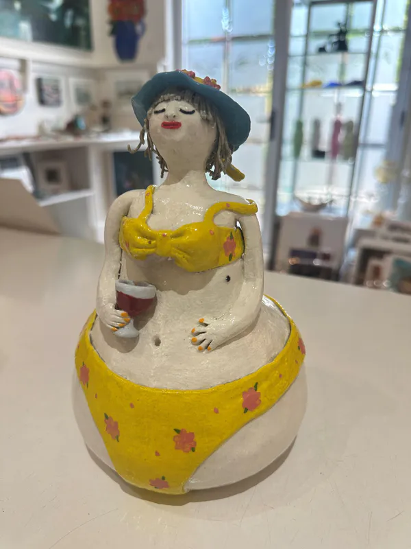An original quirky ceramic figure of a lady in a Yellow bikini by LeeBee, available at The Little Gallery Whangamatā