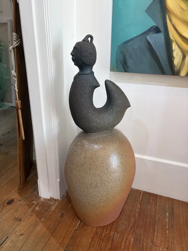 A handmade figure sculpted from clay by Ian Webster, available at The Little Gallery Whangamata