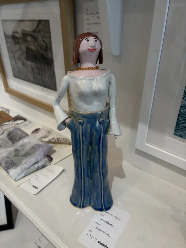 An original quirky ceramic figure of a lady in high-waisted jeans by LeeBee, available at The Little Gallery Whangamatā