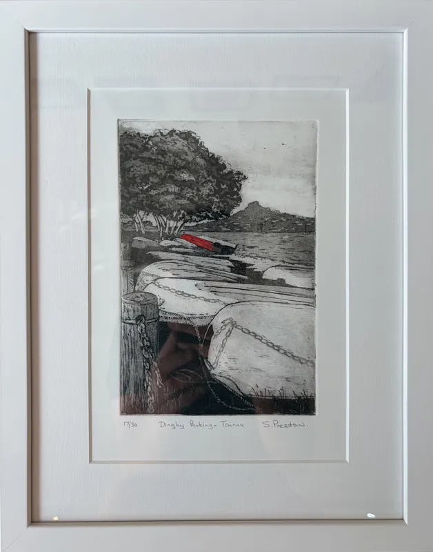 A limited edition hand-coloured print of dinghies parked by Sue Preston, available at The Little Gallery Tairua
