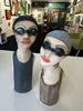 Tall Swimming Lady sculptures with swimming caps by Nikky Seales, available at The Little Gallery Whangamatā