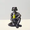 Bronze sculpture of dogman holding a green pear by Gillie and Marc available from The Little Gallery in Whangamata