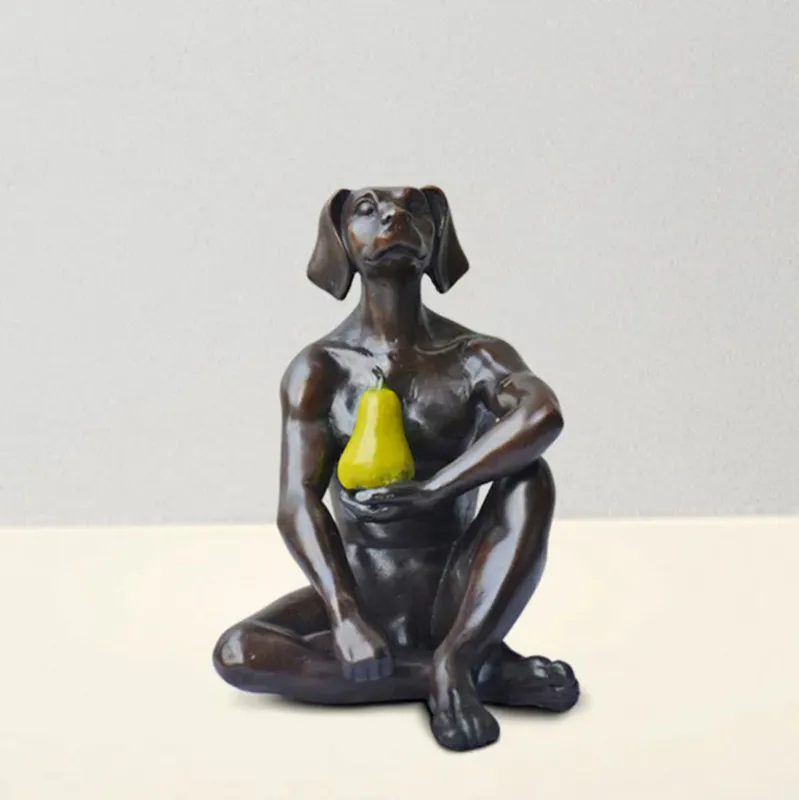 Bronze sculpture of dogman holding a green pear by Gillie and Marc available from The Little Gallery in Whangamata