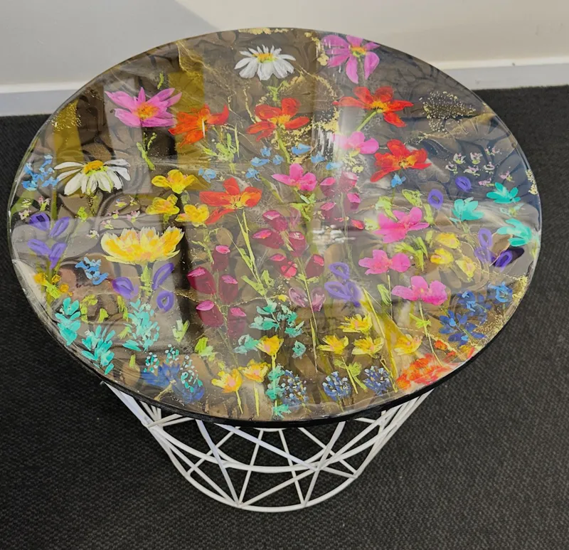 A side table with floral painted designs and resin coating by Kristin Hyde, available at The Little Gallery Whangamata