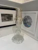 A craftfully curated recycled glass candelabra with an Orange Hurricane lamp by Sassy Maz, available at The Little Gallery Tairua