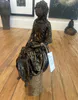 A beautifully crafted fabric and Paverpol sculpture lady sitting by Shona MacDonald, available at The Little Gallery Tairua