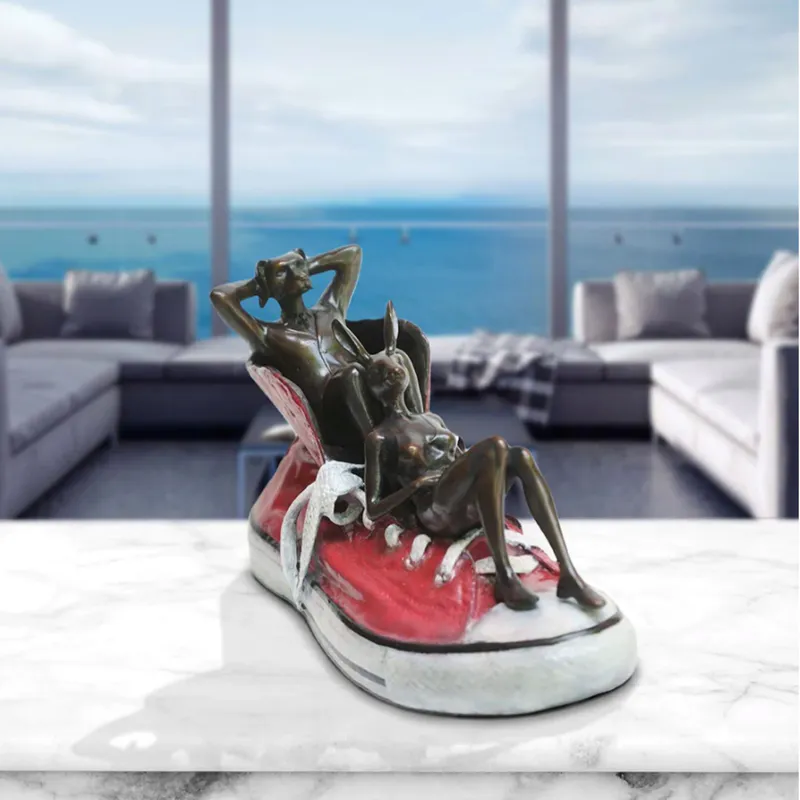 Solid bronze scupture with Dogman chilling by Gillie and Marc at The Little Gallery Whangamata