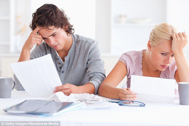 Stressed young couple looking at bills