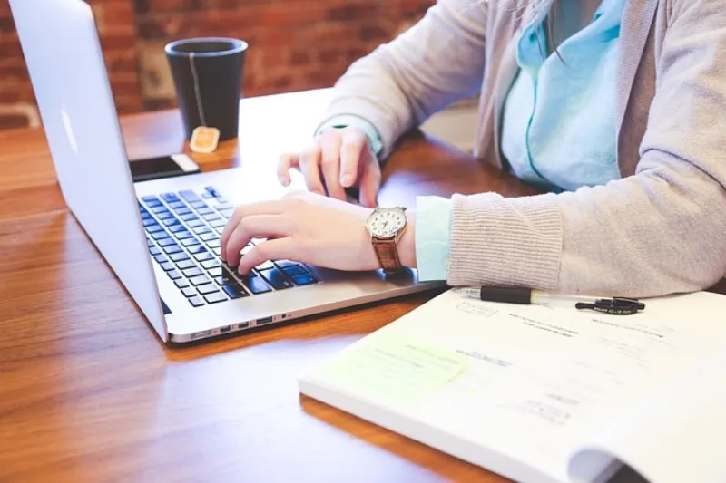 Writer typing at their desk